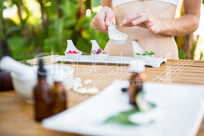 Fit woman holding plate with herbal medicine