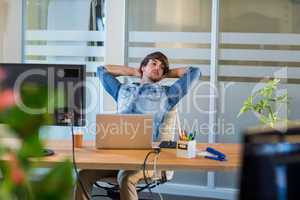 Tired businessman sitting at desk