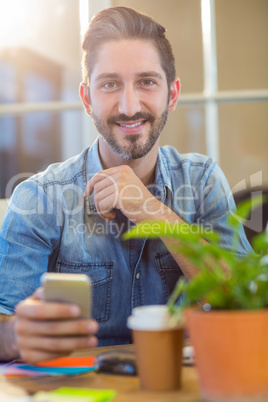 Casual businessman texting with his mobile phone