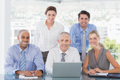 Business team during meeting smiling at camera