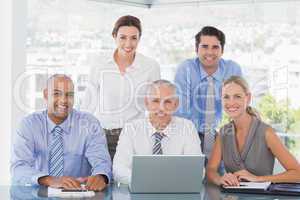 Business team during meeting smiling at camera