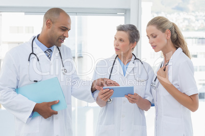 Team of smiling doctors working on their files