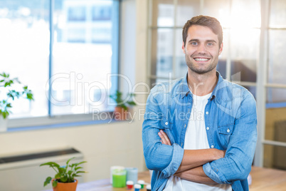 Casual businessman smiling at camera with arms crossed Casual businessman smiling at camera with arms crossed