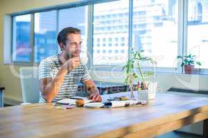 Casual businessman drinking coffee at his desk