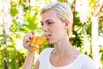 Attractive blonde woman drinking tea