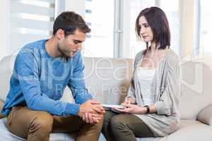 Psychologist talking with depressed man