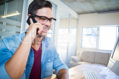 Casual businessman speaking at the phone Casual businessman speaking at the phone