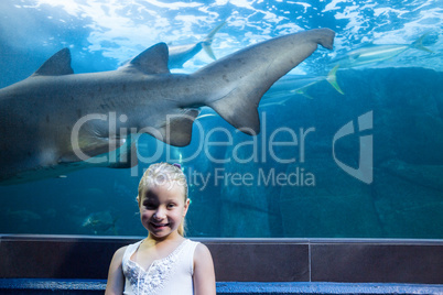 Young woman behind a shark tank looking at camera