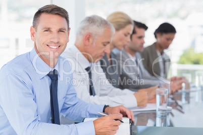 Business team taking notes during conference