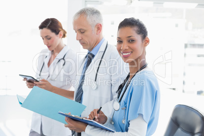 Doctors working together on patients file