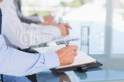 Business team taking notes during conference