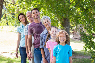 Extended family smiling in the park