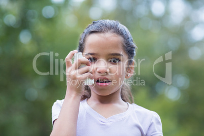 Little boy using his inhaler