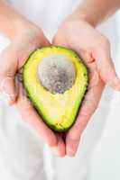 Woman holding fresh avocado