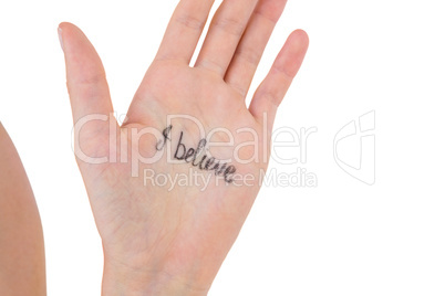 Hand showing the words I believe