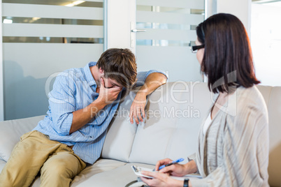 Psychologist talking with depressed man