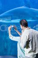 Happy couple taking a picture of a shark