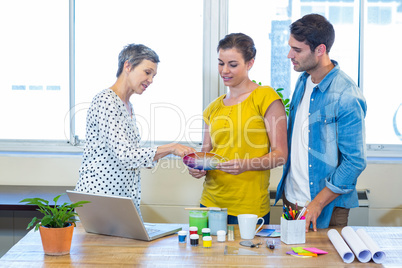 Casual business team discussing about colour chart