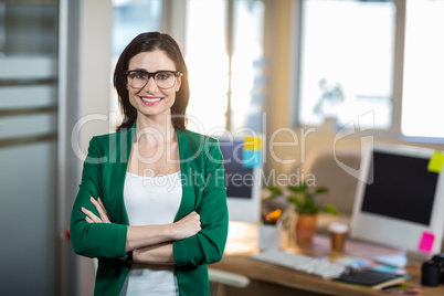 Smiling brunette standing arms crossed