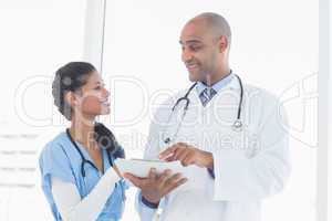 Smiling doctors reading files