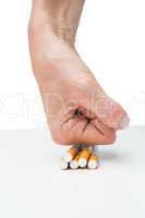 Hand squashing batch of cigarettes
