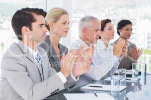 Business team applauding during conference