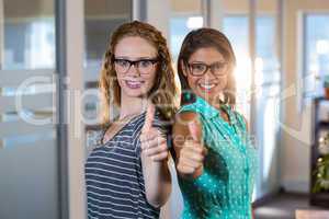 Portrait of smiling partners posing together thumbs up
