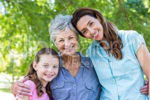 Extended family smiling in the park