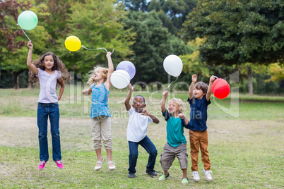 Happy children holding balloons