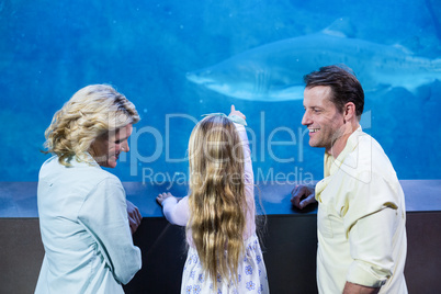 Happy family looking at the fish tank