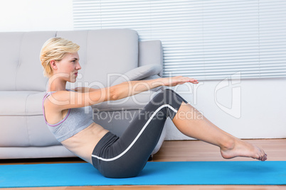 Fit blonde woman doing sit ups