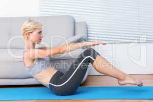 Fit blonde woman doing sit ups