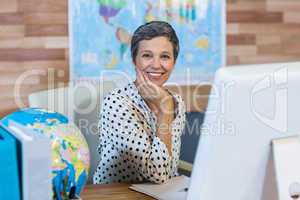 Smiling businesswoman sitting at her desk