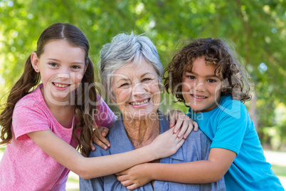 Extended family smiling and kissing in a park