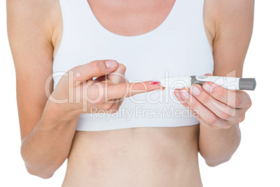 Woman doing test with blood glucose monitor