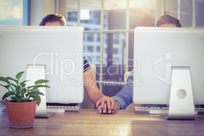 Couple holding hands at work