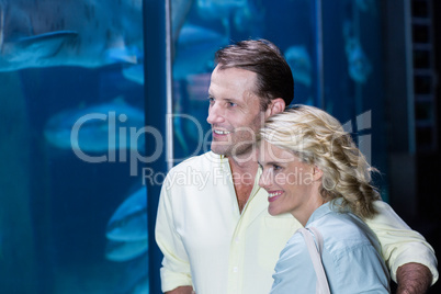 Happy couple looking at fish tank