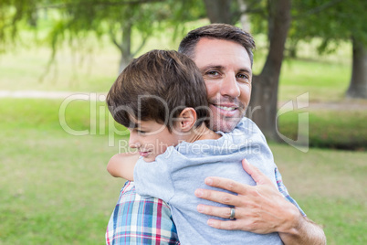 Father and son hugging in the park