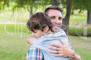 Father and son hugging in the park