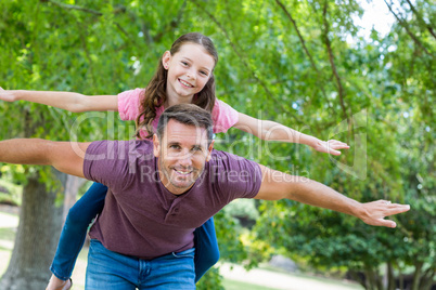 Father and daughter having fun in the park