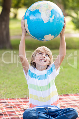 Little boy holding a globe