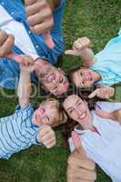 Happy family in the park together thumbs up