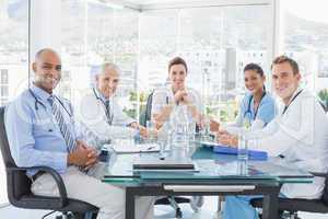 Team of smiling doctors having a meeting