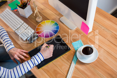Designer working with colour wheel and digitizer