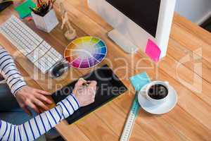 Designer working with colour wheel and digitizer