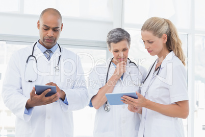 Team of smiling doctors working on their files