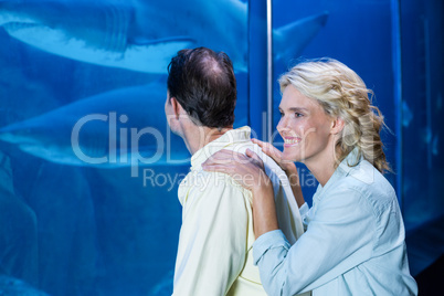 Happy couple looking at fish tank