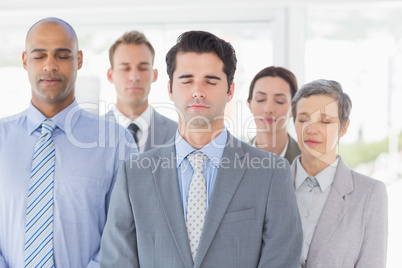 Business team relaxing eyes closed