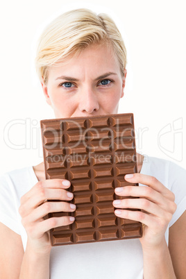 Attractive woman holding big bar of chocolate