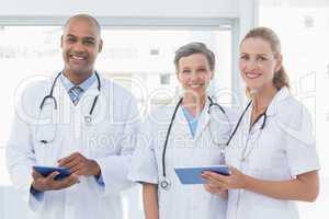 Team of smiling doctors working on their files